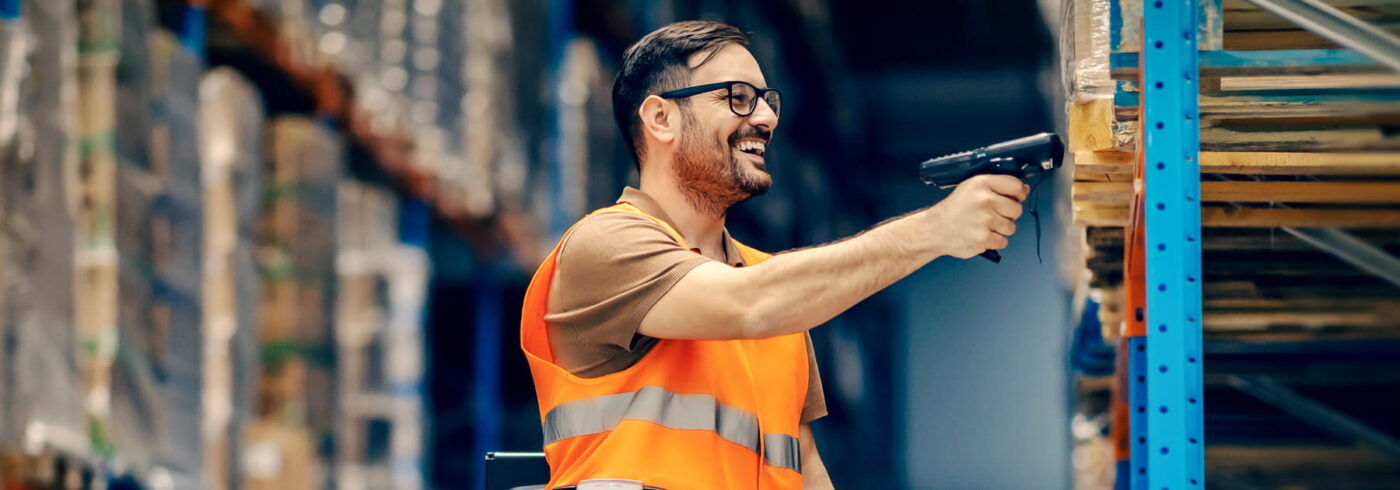 warehouse worker scanning a package with a mobile barcode reader